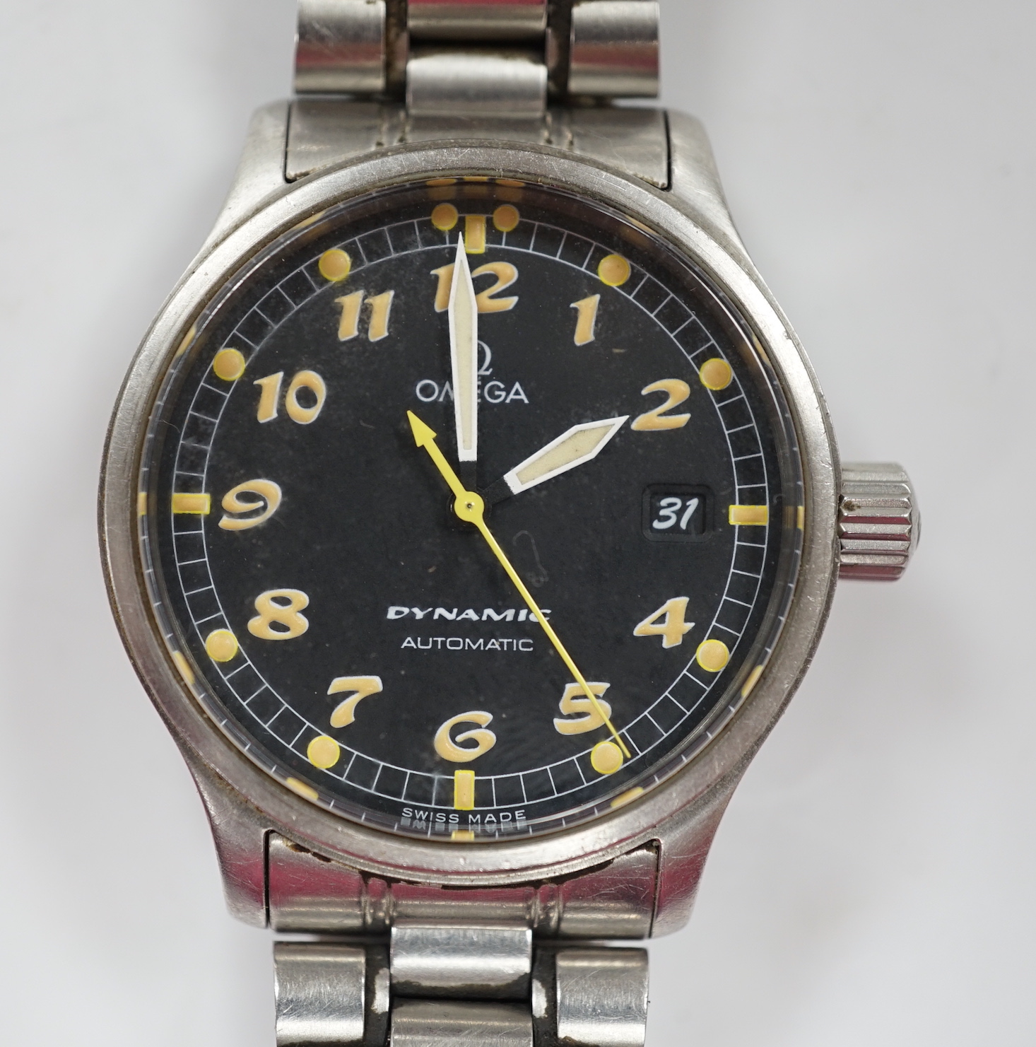 A gentleman's stainless steel Omega Dynamic automatic wrist watch, with black dial and date aperture, on a stainless steel bracelet, no box or papers, case diameter 37mm.